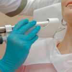 Close-up of a woman receiving a laser skin treatment in a clinic.